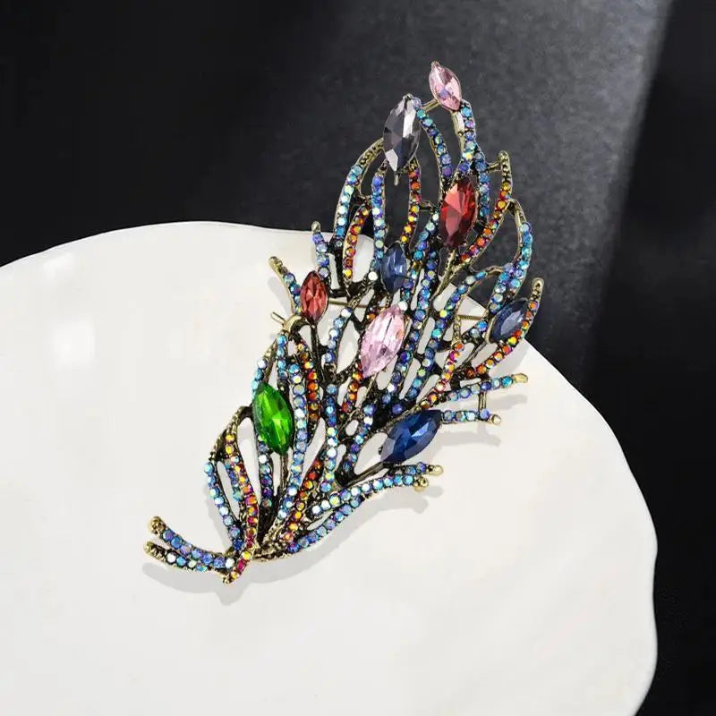 Multicolored jeweled brooch on a white surface with a dark background