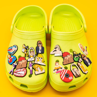 Yellow clogs with various colorful pins on a yellow background