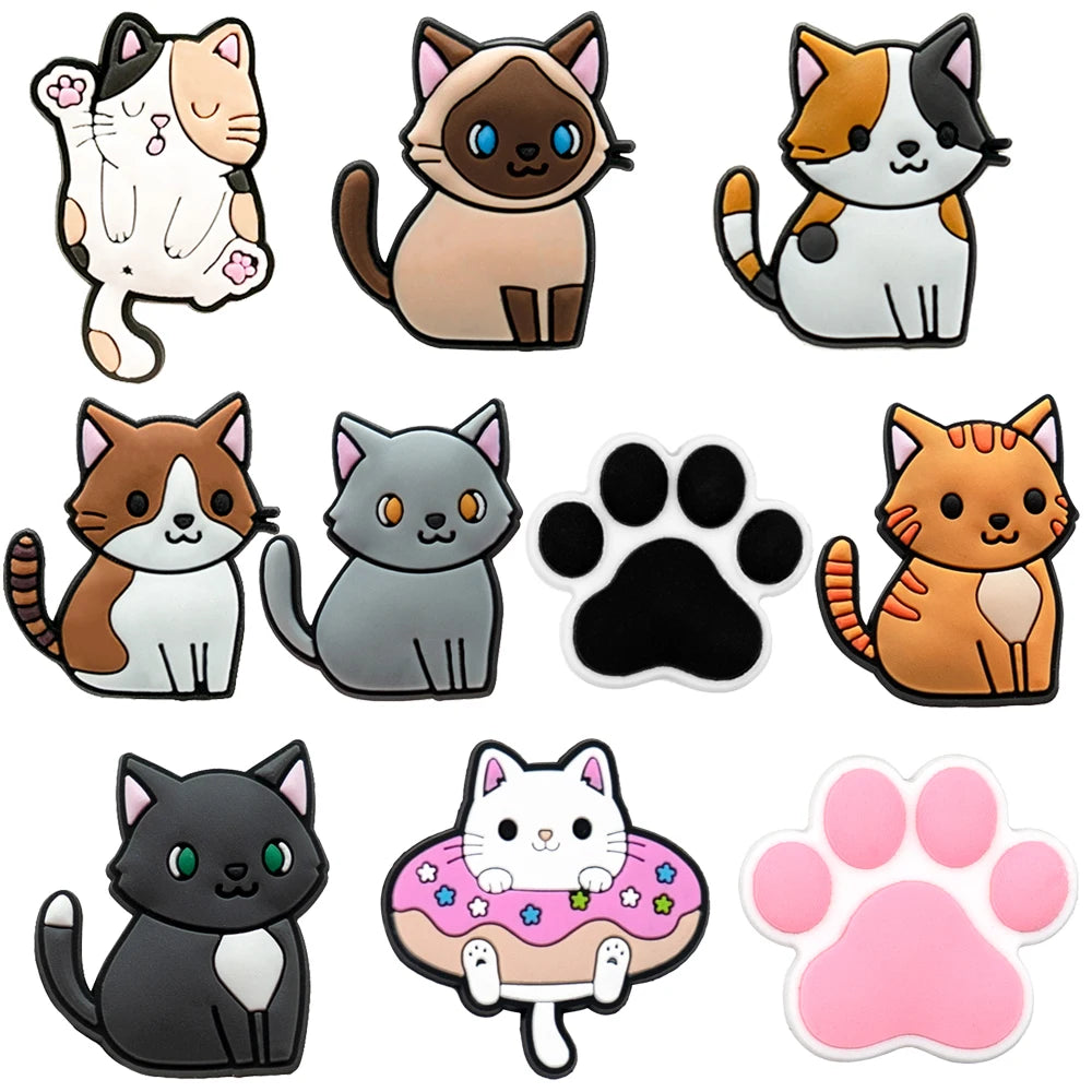Set of cartoon cat shoe charms and paw prints on a white background