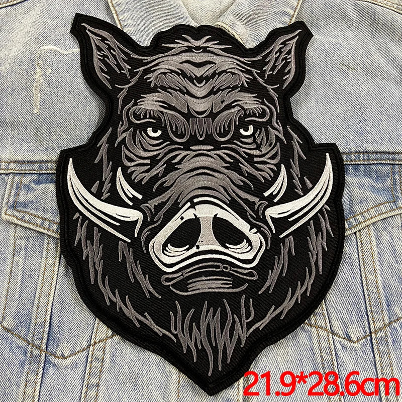 Patches with a stylized boar design on a denim background