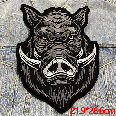 Patches with a stylized boar design on a denim background