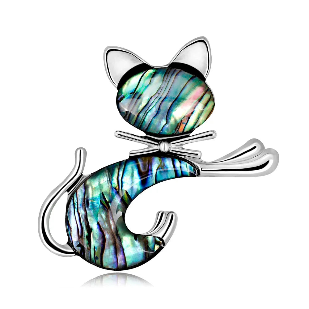 Cat-shaped brooch with abalone shell inlay on a white background