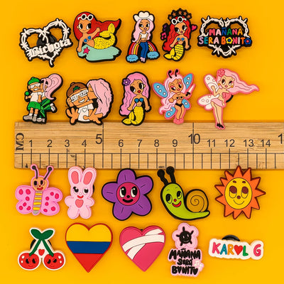 Collection of colorful cartoon-style pins on a yellow background with a ruler for scale.