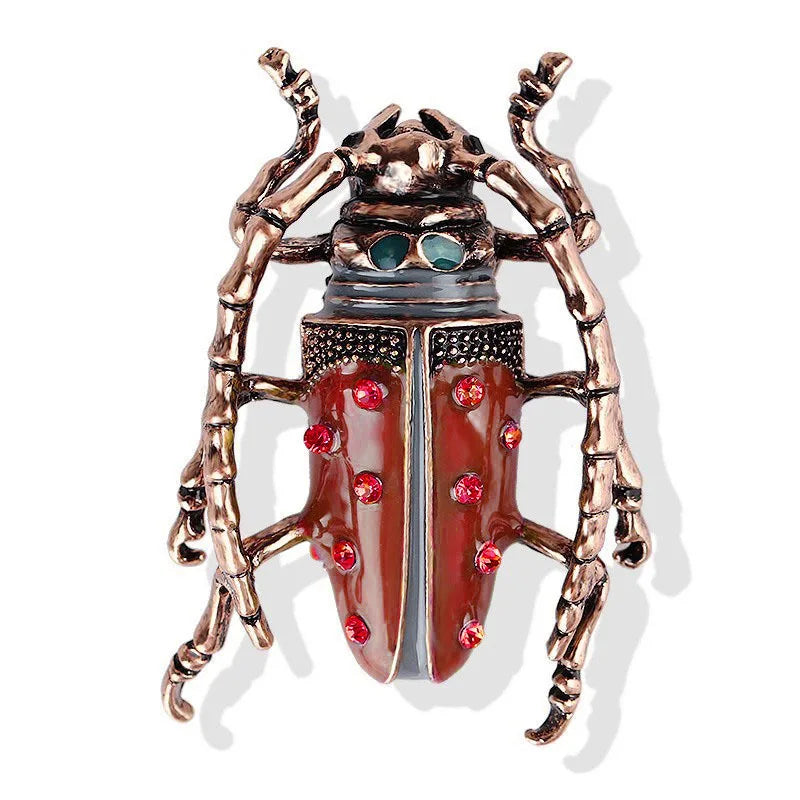Decorative beetle-shaped object with red and green accents on a white background