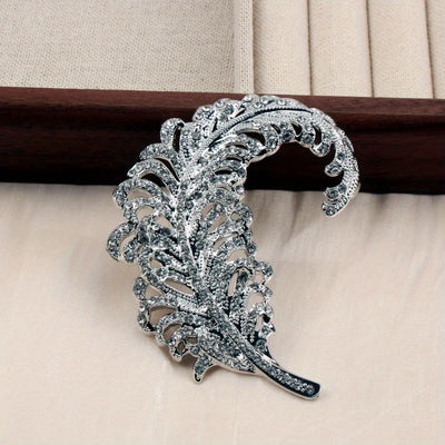 Decorative silver brooch on a beige background
