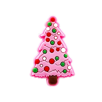 Shoe charm ornament of Pink Christmas tree-shaped object with red and green decorations on a white background