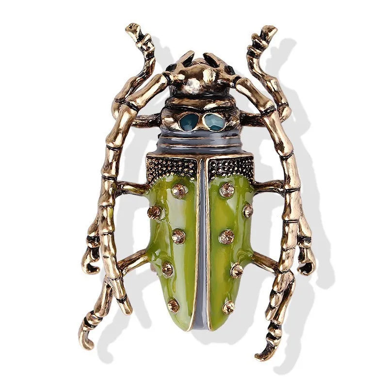 Decorative beetle with green body and gold wings on a white background