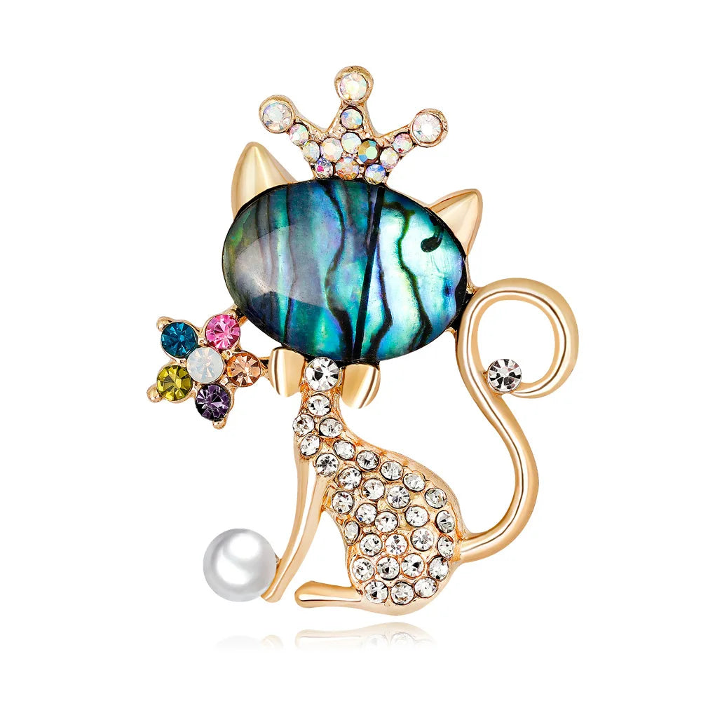 Cat-shaped brooch with gemstones on a white background