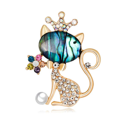 Cat-shaped brooch with gemstones on a white background