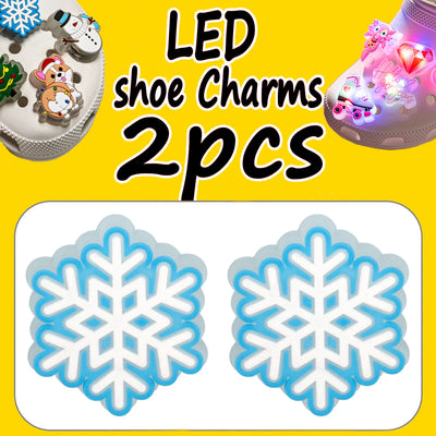 LED shoe charms with snowflake design on a yellow background