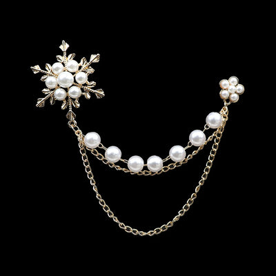 Pearl and gold chain earring on a black background