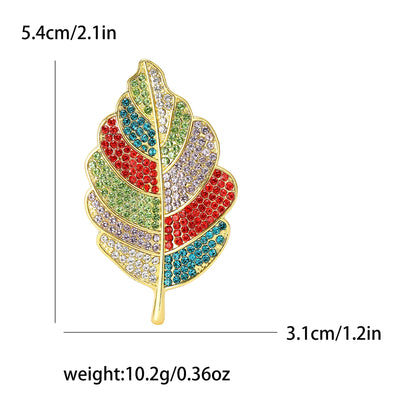 Colorful feather-shaped brooch with measurements and weight on a white background