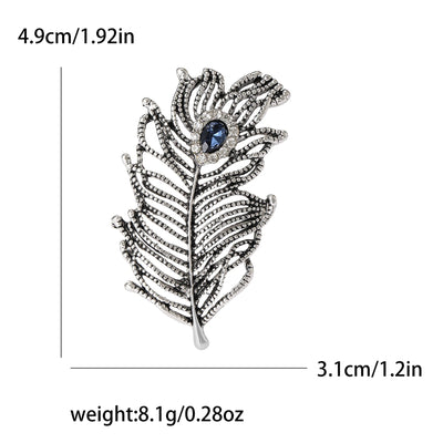 Decorative feather brooch with gemstone, shown with measurements and weight on a white background.