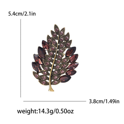 Leaf-shaped brooch with measurements and weight details on a white background