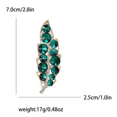 Green gemstone brooch with measurements and weight on a white background
