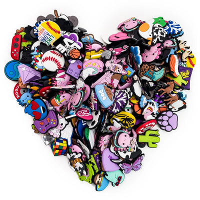 Collection of colorful shoe charms shaped like cartoon characters on a white background