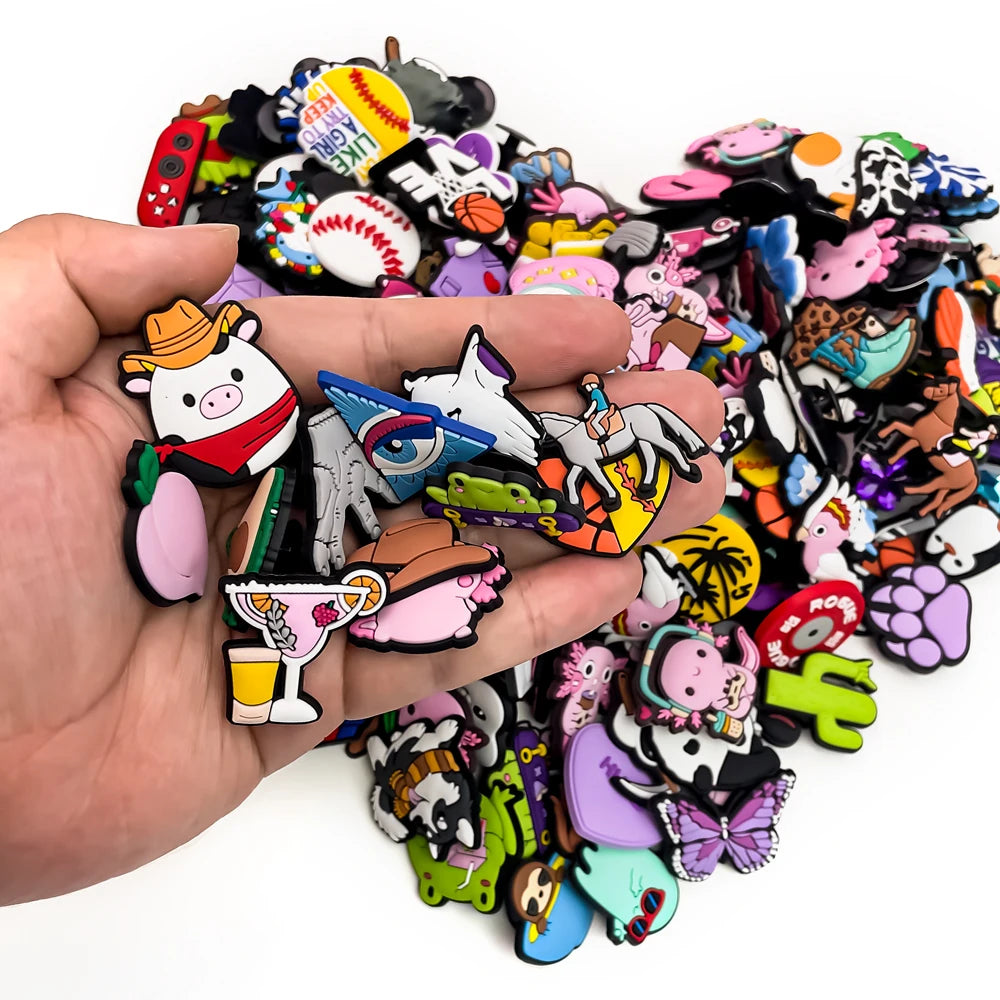 Hand holding a collection of colorful cartoon-style shoe charms  with a white background