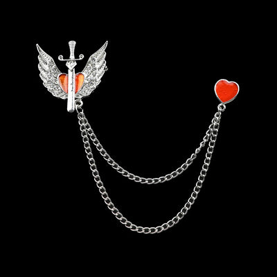 Brooch with sword, wings, and red heart on a black background