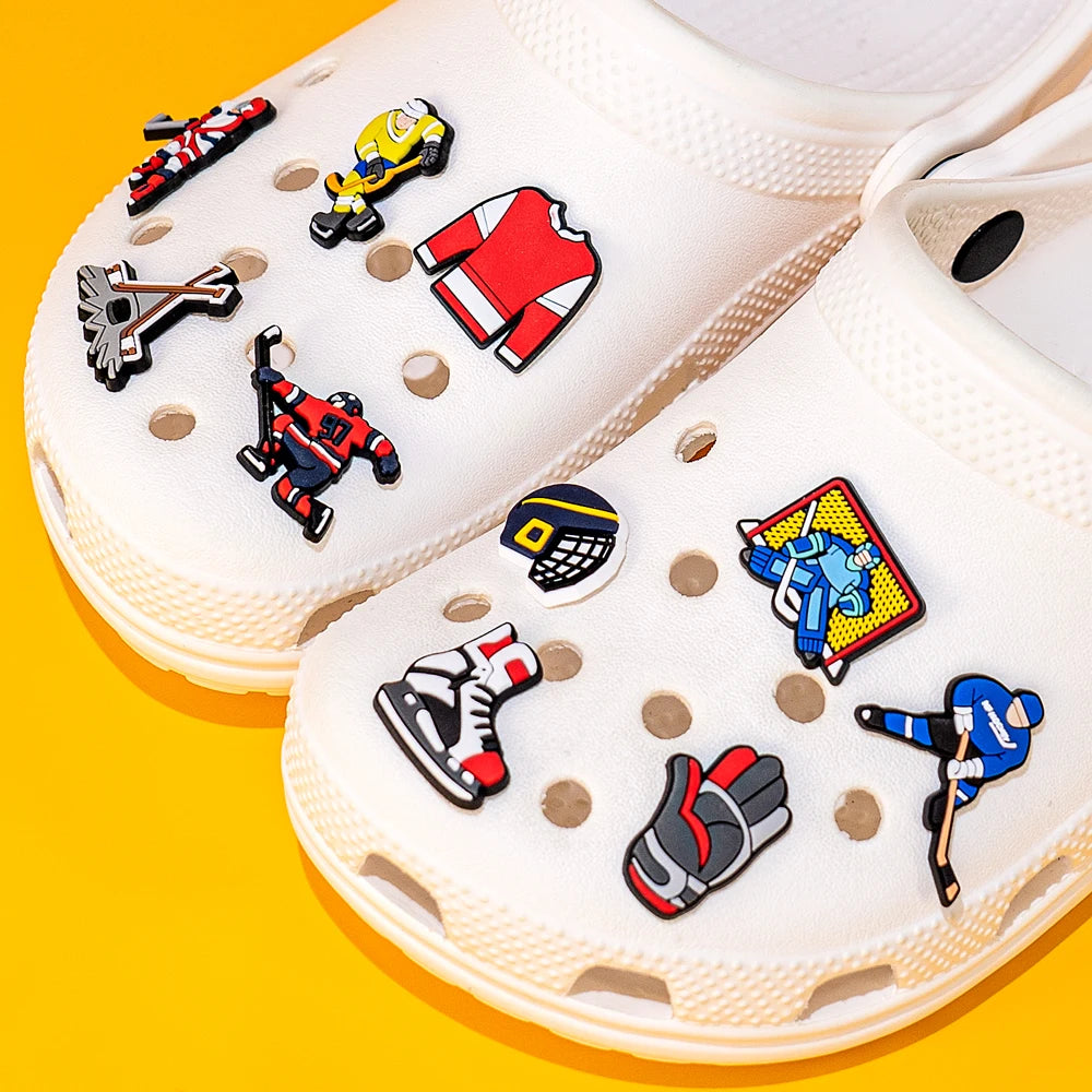 White clogs with colorful shoe charms on a yellow background