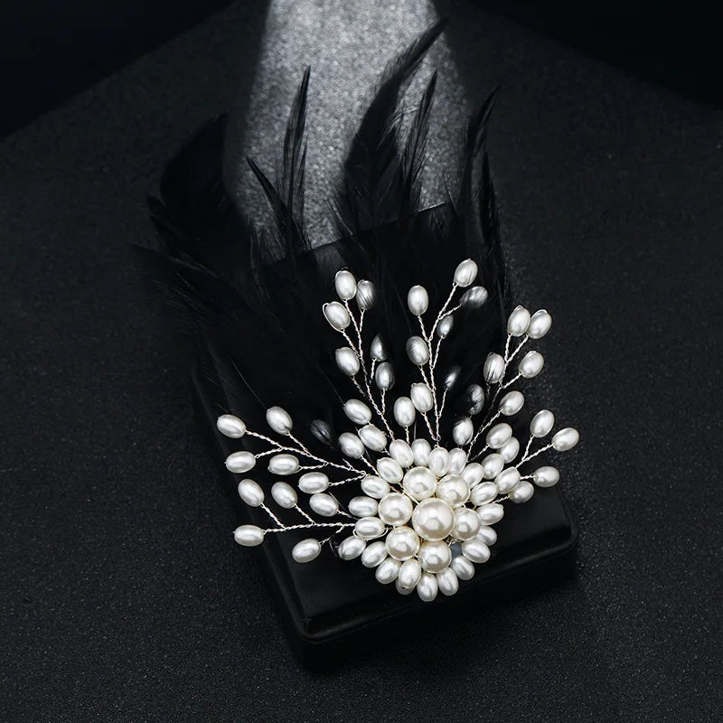 Pearl brooch with feathers on a black background