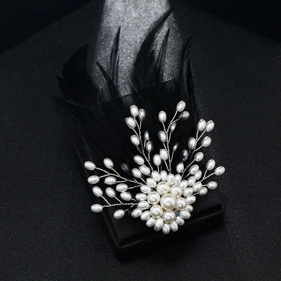 Pearl brooch with feathers on a black background