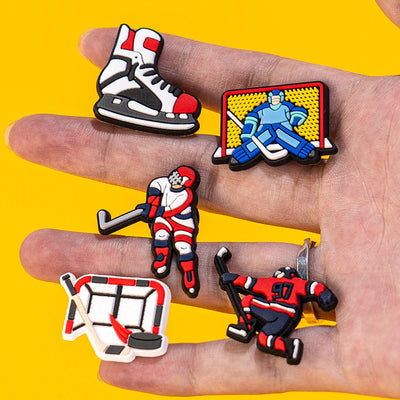 Collection of hockey-themed charms on a hand with a yellow background