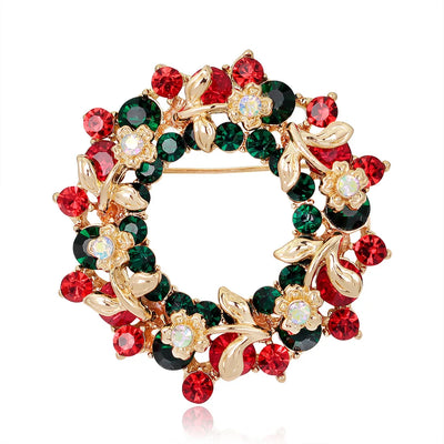 Decorative brooch with red, green, and gold gemstones on a white background