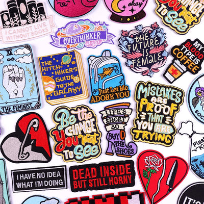 Collection of colorful patches with various designs and text on a white background