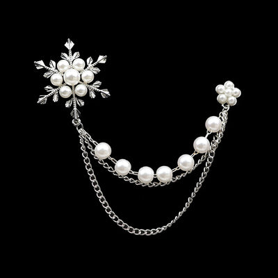 Pearl and silver chain accessory on a black background