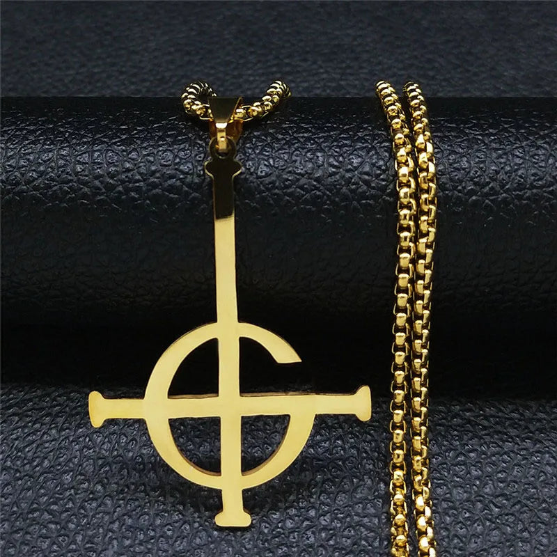 Gold pendant with chain on a textured black surface