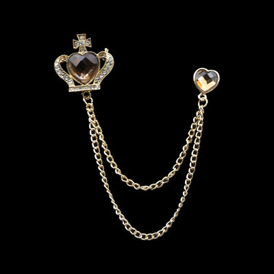 Decorative brooch with heart and crown design on a black background