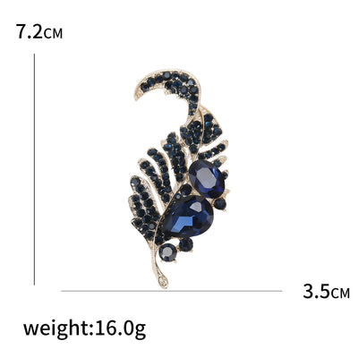 Jewelry brooch with blue stones and gold accents, shown with measurements and weight on a white background.