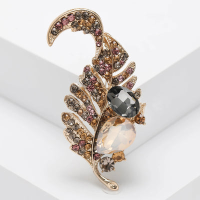 Decorative brooch with gemstones on a white background