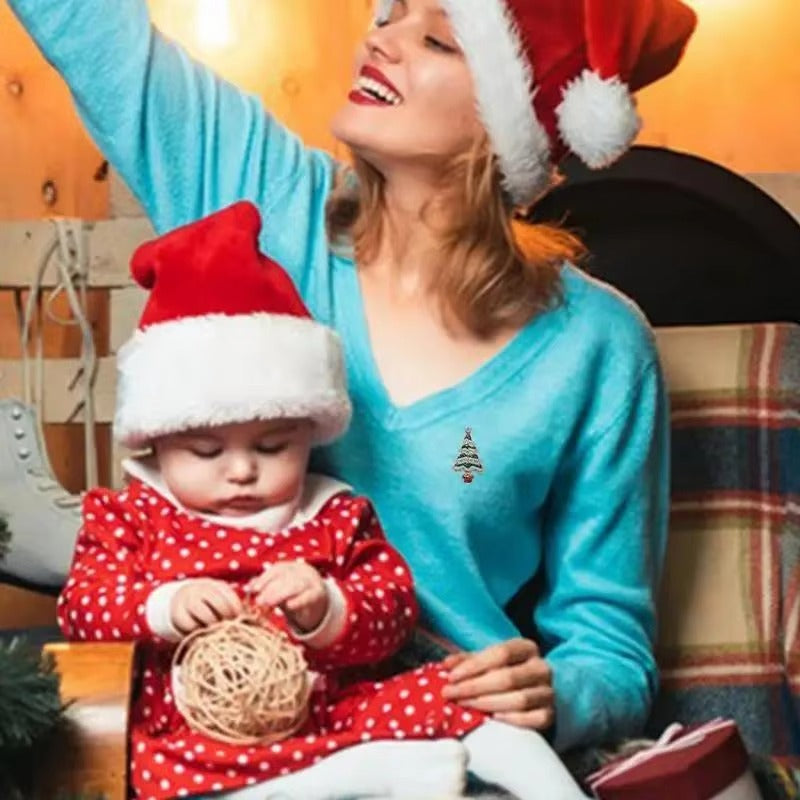 Woman and child wearing Santa hats with a Christmas tree in the background