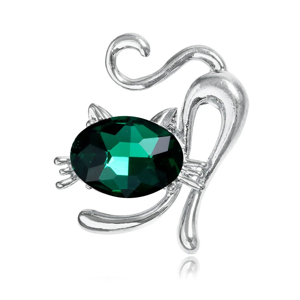 Silver cat -shaped brooch with a green gemstone on a white background