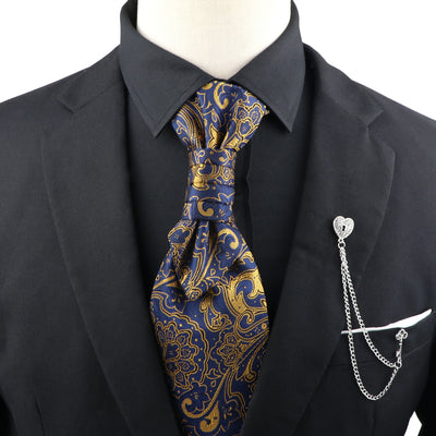 Mannequin wearing a black suit with a blue and gold paisley tie and a silver pocket knife on a white background