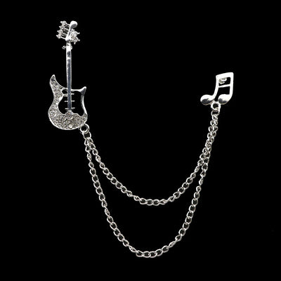 Silver brooch with guitar and music note design on a black background