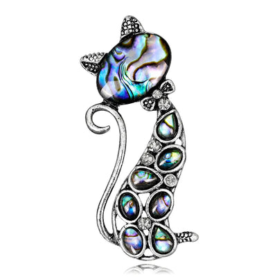 Cat-shaped brooch with abalone shell and crystal accents on a white background