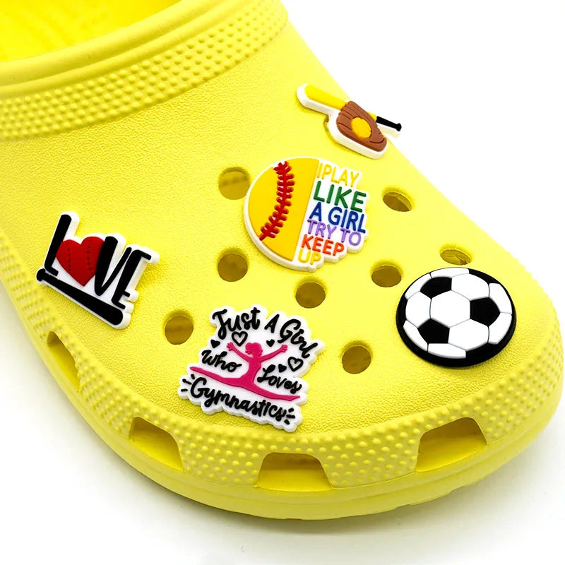 Yellow clog shoe with various colorful shoe charms on a white background