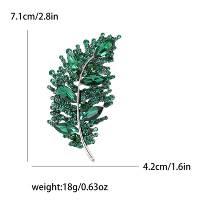 Green leaf-shaped brooch with measurements and weight details on a white background