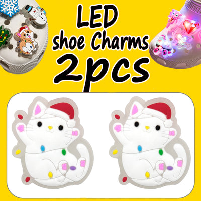 LED shoe charms with a cat design on a yellow background