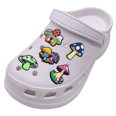 White clog shoe with colorful mushroom-shaped charms on a white background