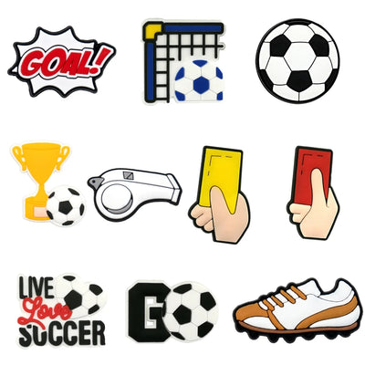 Collection of soccer-themed shoe charms including a goal, soccer ball, trophy, whistle, cards, and cleats on a white background.