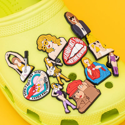 Colorful shoe charms on a yellow shoe with a bright yellow background