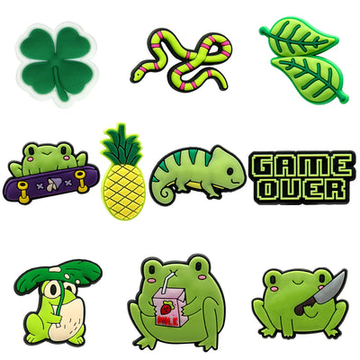 Collection of green cartoon-style shoe charms with various designs on a white background