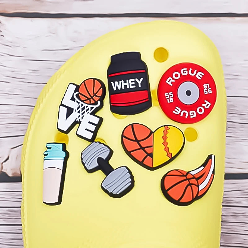 Yellow clog with sports-themed  various shoe charms on a wooden surface