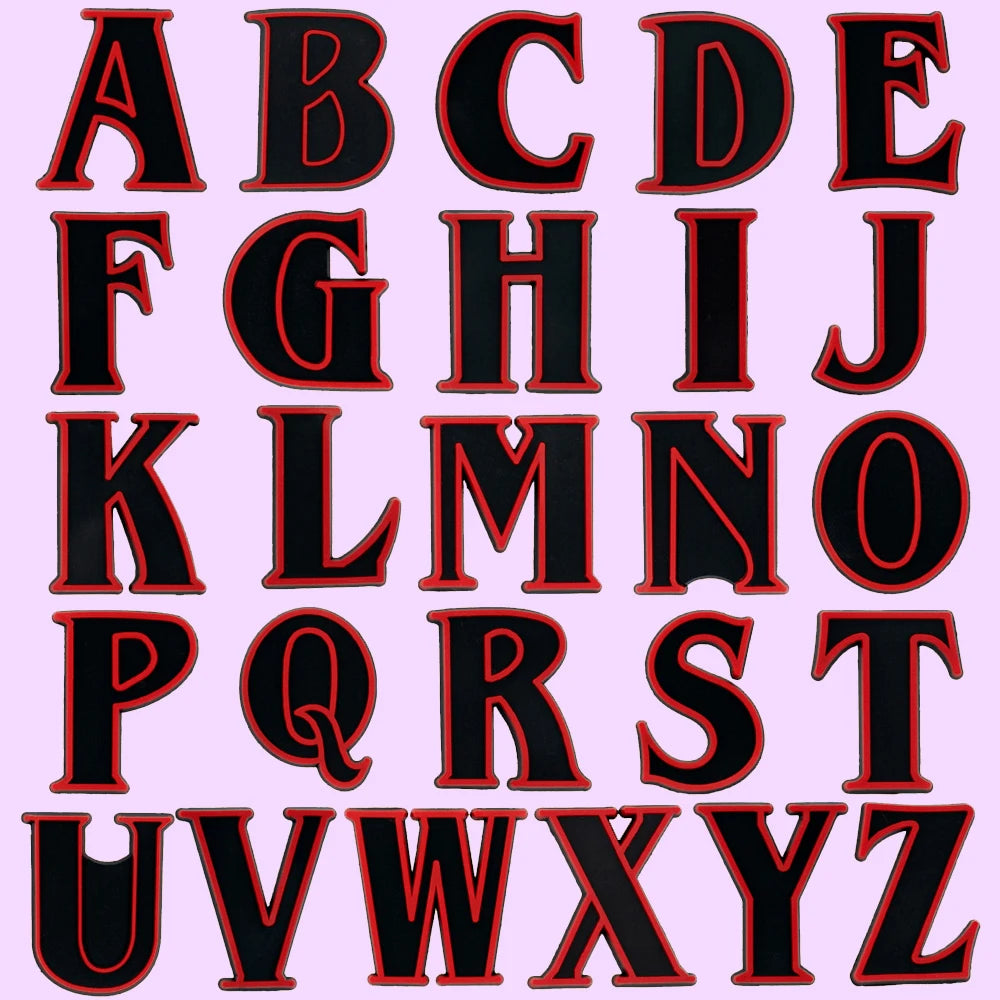 shoe charms Black letters of the alphabet with red borders on a pink background