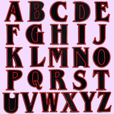 shoe charms Black letters of the alphabet with red borders on a pink background