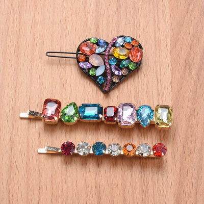 front view of a colorful gemstone hair clips on a wooden surface