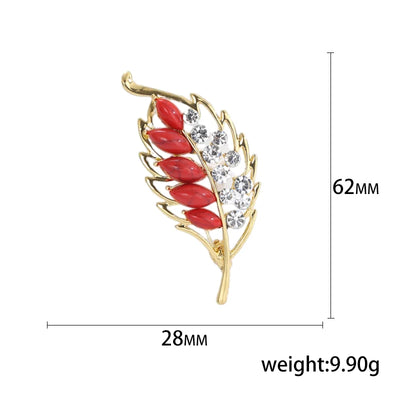 Jewelry brooch with red leaves and gold frame, shown with measurements and weight on a white background.